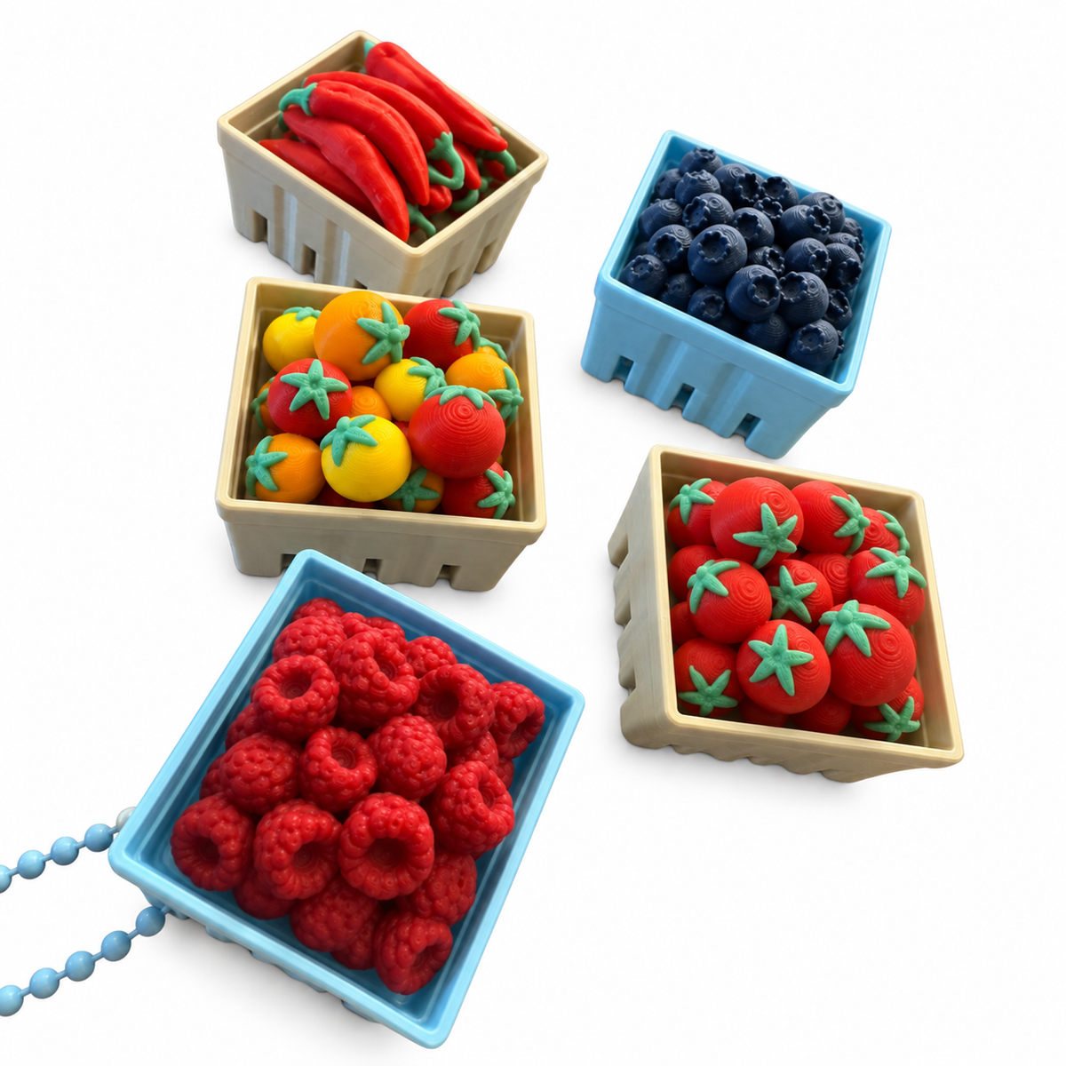 The full Harvest Basket lineup — chile peppers, mixed tomatoes, red tomatoes, blueberries and raspberries, one on a keychain